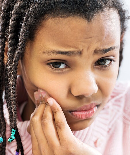 little girl with tooth pain