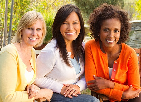 three women smiling together