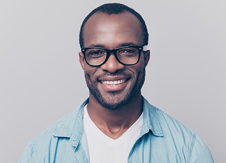 man with glasses smiling