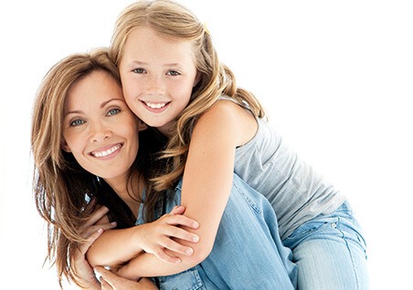 mother holding daughter on her back