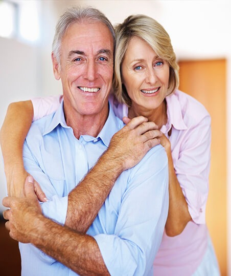 husband and wife smiling