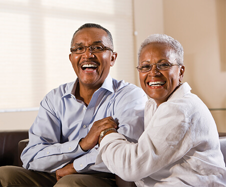 husband and wife smiling