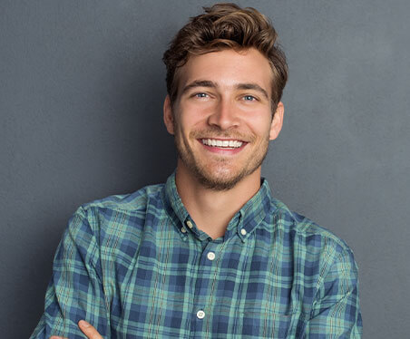 man smiling with straight white teeth