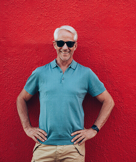 smiling man with red background