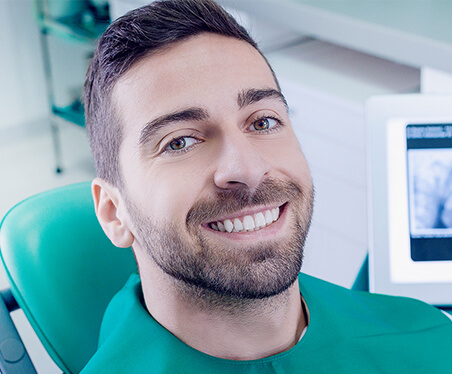 smiling man in dental chair