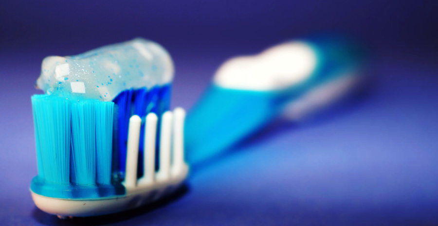 Toothbrush loaded with sparkling toothpaste.