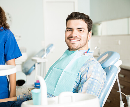 smiling man sitting in a dental chair