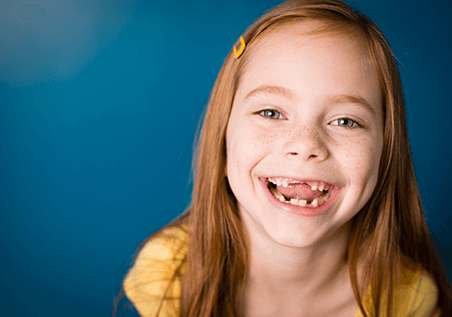 young girl with no front teeth